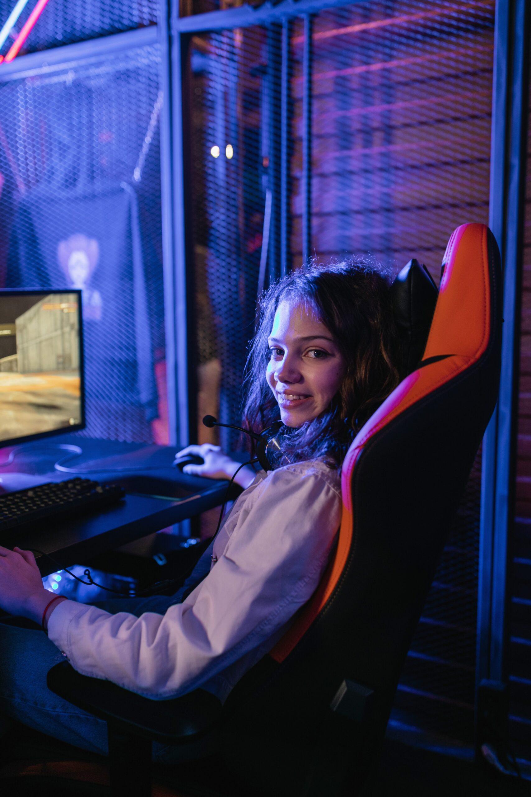 Gamer girl playing video game on laptop