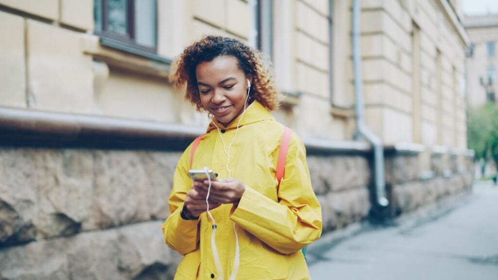 Person listening to music with wireless earbuds while jogging