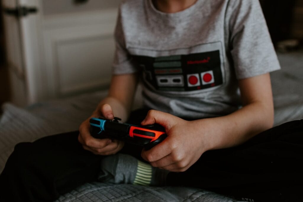 A person playing a game on a laptop in a relaxed home setting