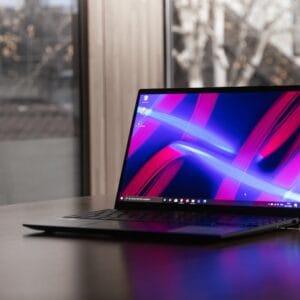 A professional using the ASUS Zenbook A14 on a train with its backlit keyboard lit