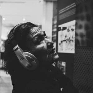 A traveler wearing Bose QuietComfort Ultra headphones on a plane, immersed in spatial audio