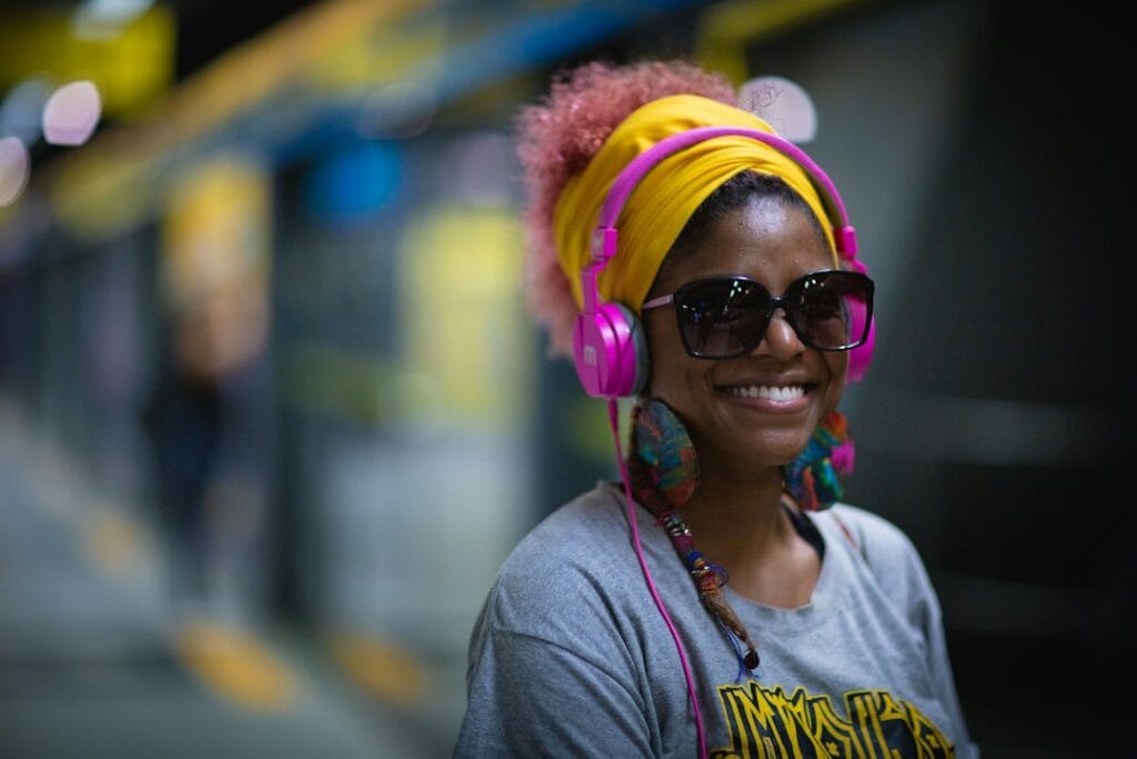 Person wearing Sony WH-1000XM6 headphones while working on a laptop in a café
