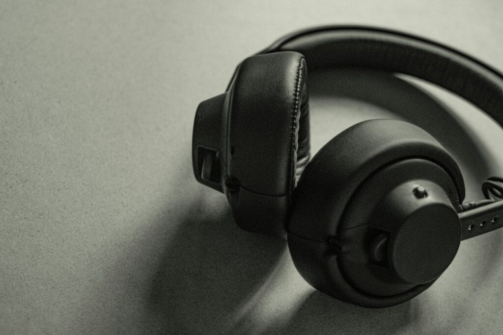 Black over-ear headphones on a grey surface