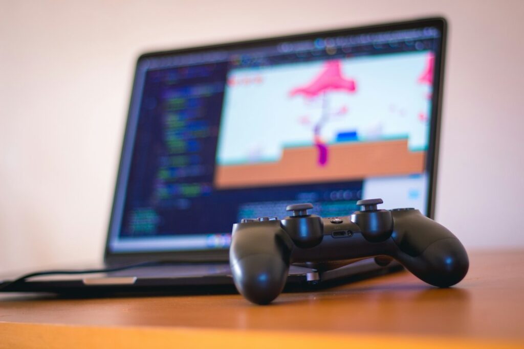 Gaming laptop next to a game controller