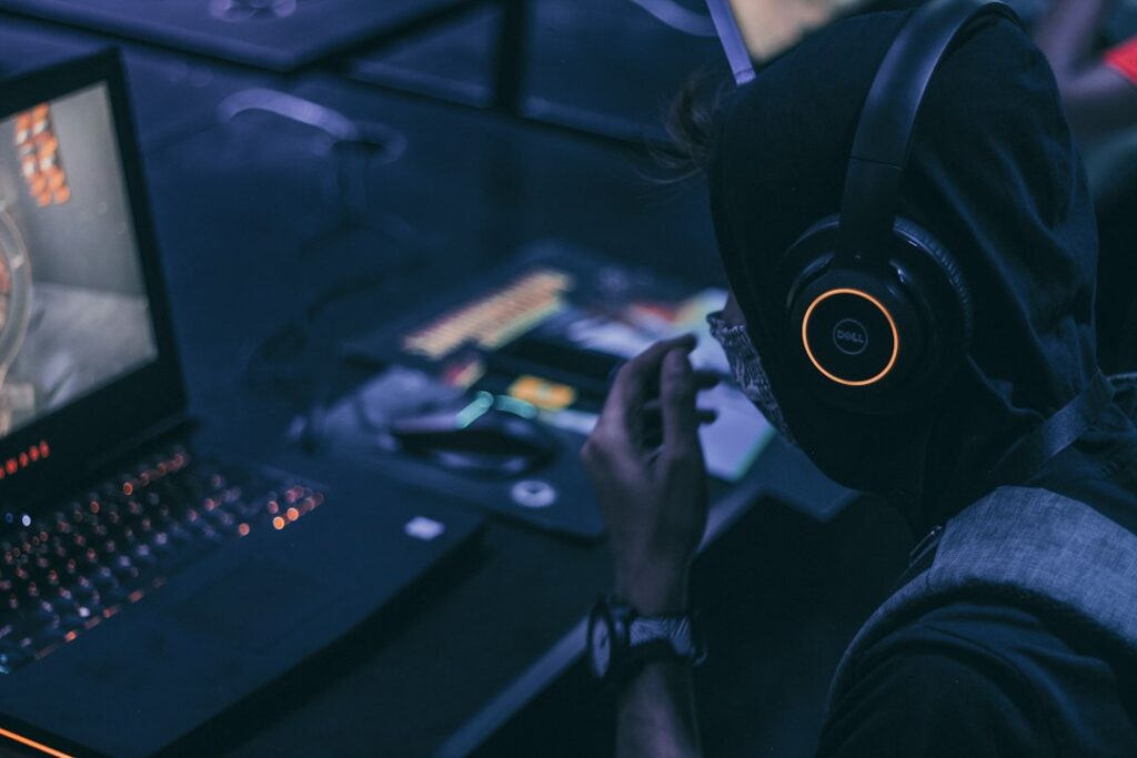 Person playing a game on a gaming laptop